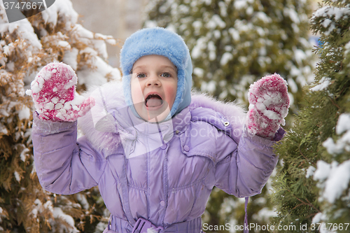 Image of Girl afraid of jumping out of the snow-covered trees