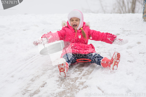 Image of Girl closing her eyes and opening the ice kind of rolling hills