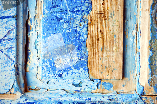Image of dirty   paint in   blue wood  rusty nail