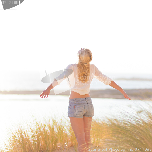 Image of Free Happy Woman Enjoying Sun on Vacations.