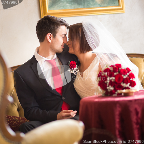 Image of Beautiful wedding couple kissing.