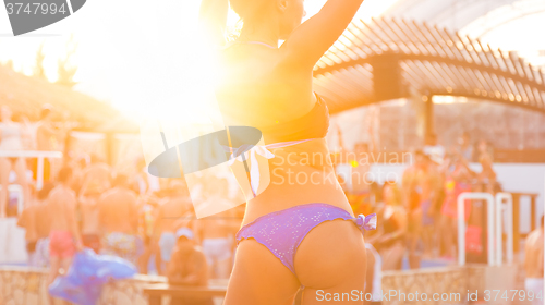 Image of Sexy girl dancing on a beach party.