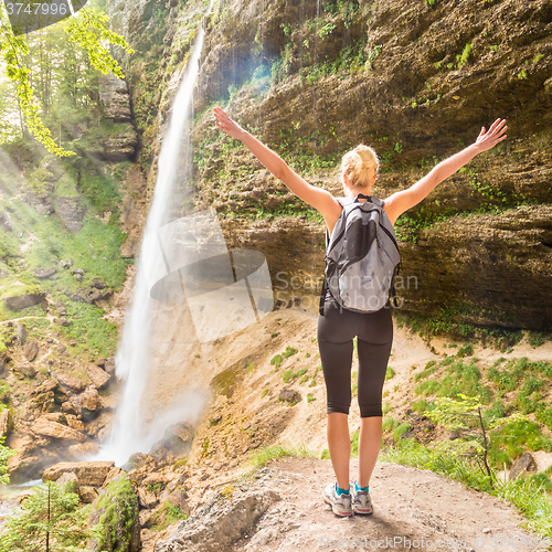 Image of Active sporty woman relaxing in beautiful nature.