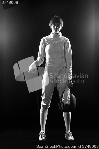 Image of The portrait of woman wearing white fencing costume  on black 