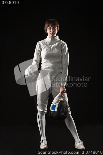 Image of The portrait of woman wearing white fencing costume  on black 