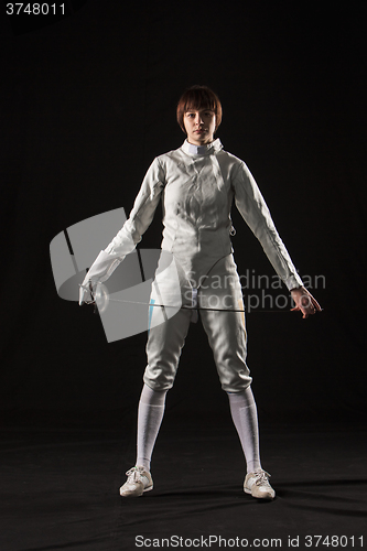 Image of The portrait of woman wearing white fencing costume  on black 