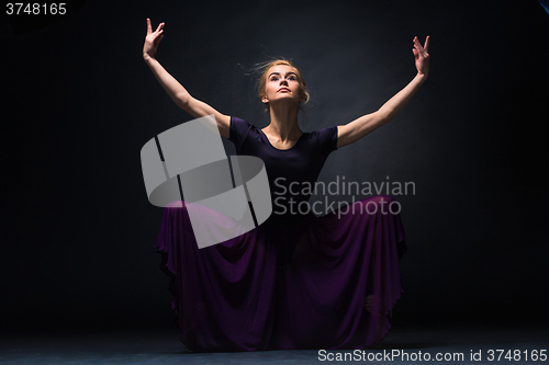 Image of Young beautiful modern style dancer posing on a studio background