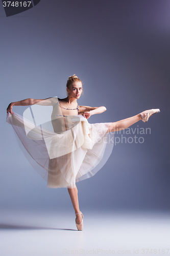 Image of Young beautiful ballerina dancer dancing on a studio background