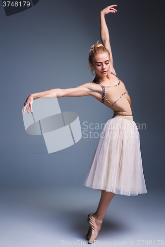Image of Young beautiful ballerina dancer dancing on a studio background