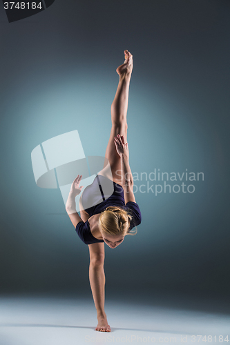 Image of Young beautiful modern style dancer posing on a studio background