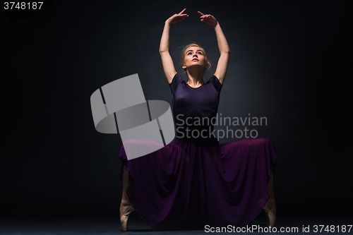 Image of Young beautiful modern style dancer posing on a studio background