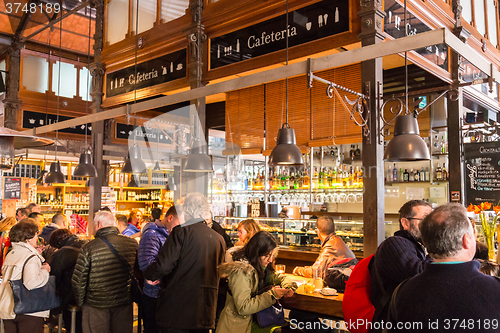 Image of People drinking and eating at San Miguel market, Madrid.