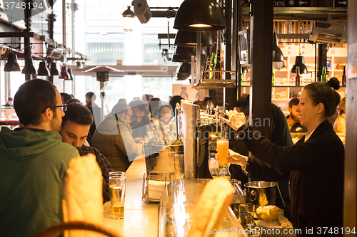 Image of People drinking and eating at San Miguel market, Madrid.