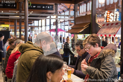 Image of People drinking and eating at San Miguel market, Madrid.