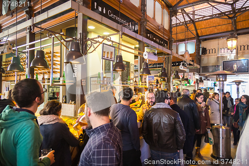 Image of People drinking and eating at San Miguel market, Madrid.