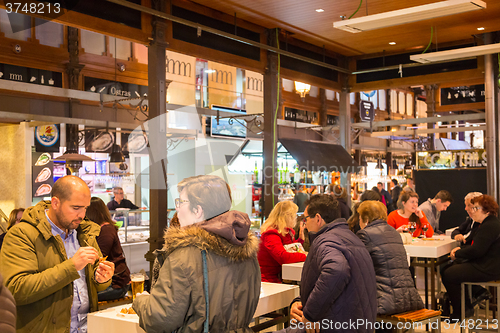 Image of People drinking and eating at San Miguel market, Madrid.