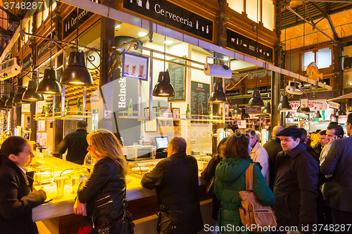 Image of People drinking and eating at San Miguel market, Madrid.