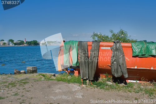 Image of Fishing boat with wet sailor uniform. Baltiysk