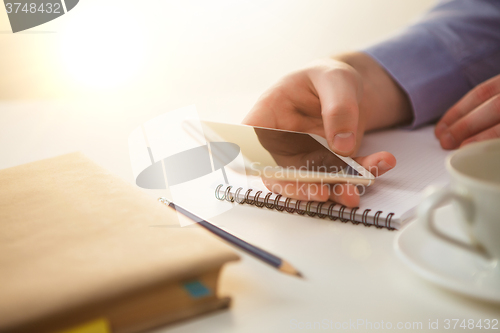 Image of The male hand holding a phone 