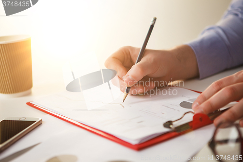 Image of The male hand drawing a graph of growth