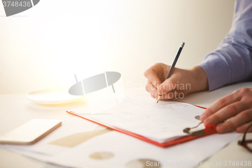 Image of The male hand drawing a graph of growth