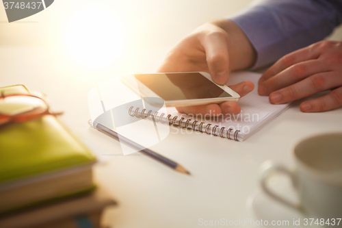 Image of The male hand holding a phone 