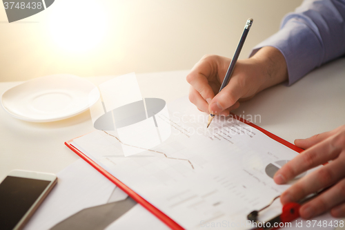 Image of The male hand drawing a graph of growth