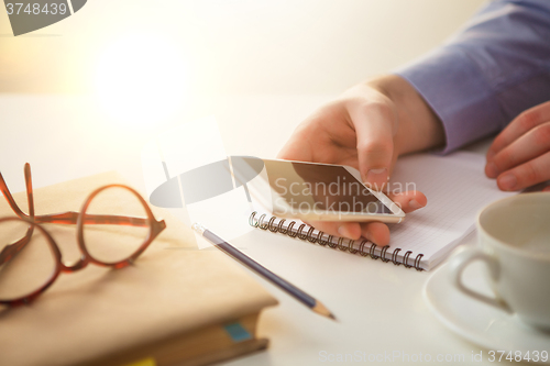 Image of The male hand holding a phone 