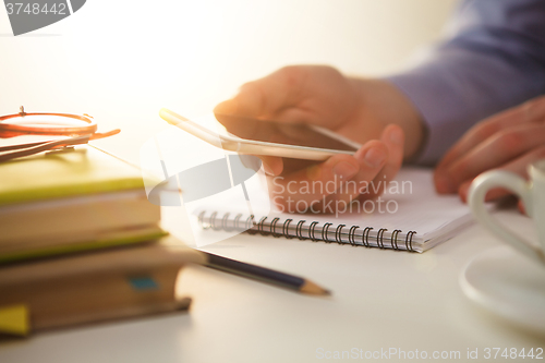 Image of The male hand holding a phone 