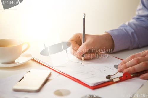 Image of The male hand drawing a graph of growth