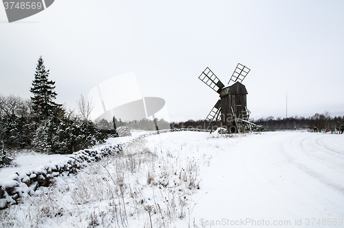 Image of Old windmill in a snowy landscape