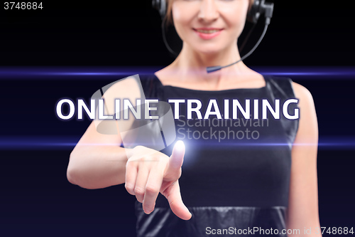 Image of business, technology, internet and networking concept - businesswoman pressing online training button on virtual screens