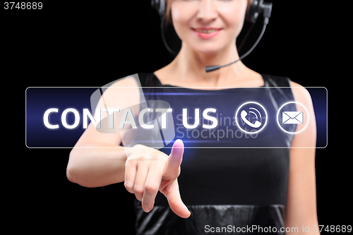 Image of business woman presses a button on the touch screen. contact us