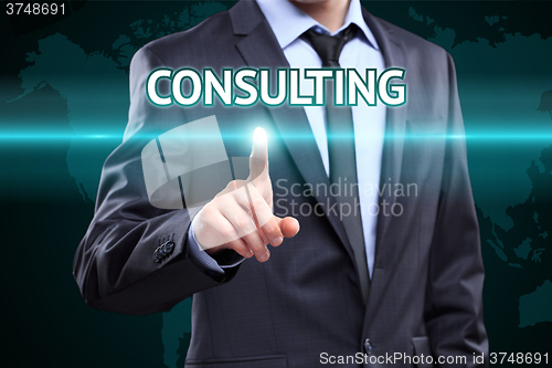 Image of Businessman pressing button on touch screen interface and select Consulting. Business,  technology concept.