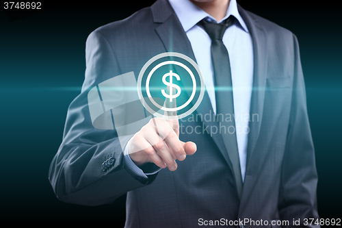 Image of Businessman presses digital interface dollar sign 