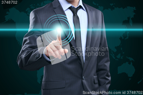 Image of business, technology, internet and networking concept - businessman pressing button with contact on virtual screens. World map