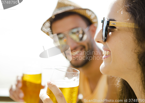 Image of Friends drinking a cold beer
