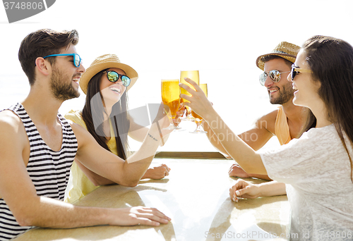 Image of Friends drinking a cold beer