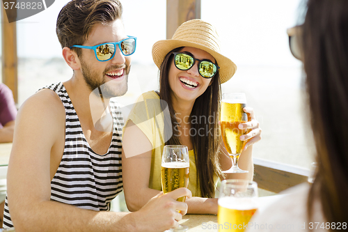 Image of Friends drinking a cold beer