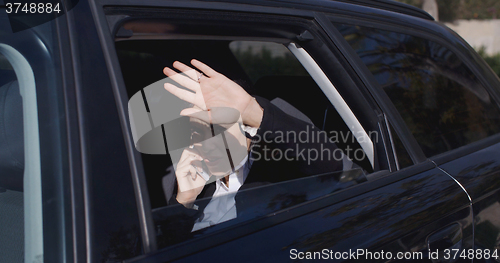 Image of Executive in car blocking view from window