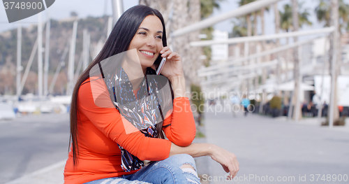 Image of Relaxed confident young woman on a mobile