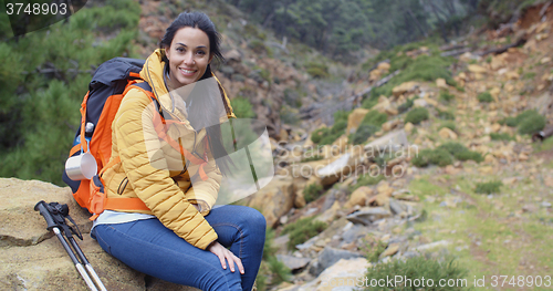 Image of Young backpacker relaxing to enjoy the view