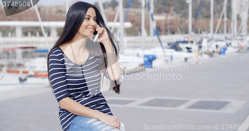 Image of Young woman on a seafront promenade