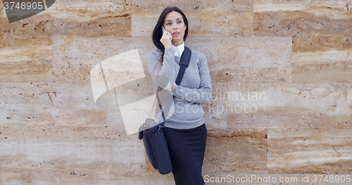 Image of Woman using phone and waiting on hold