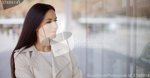 Image of Laughing vivacious woman in a town street