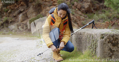 Image of Female hiker tying her laces