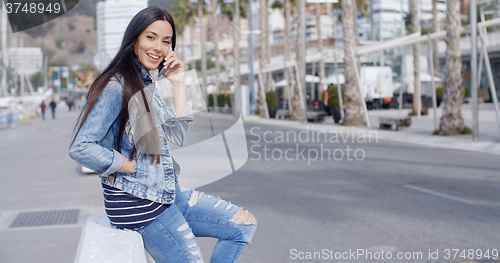 Image of Trendy attractive young woman in a denim outfit