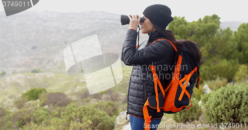 Image of Young woman hiking on a misty day