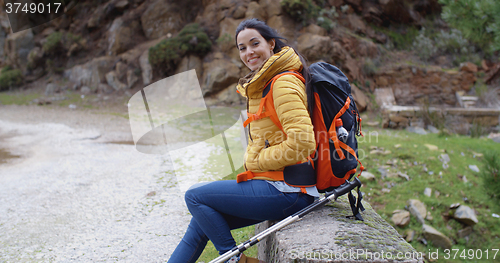 Image of Smiling young woman on a mountain trail