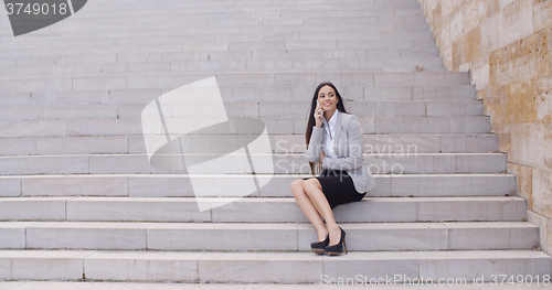 Image of Happy woman talking on phone